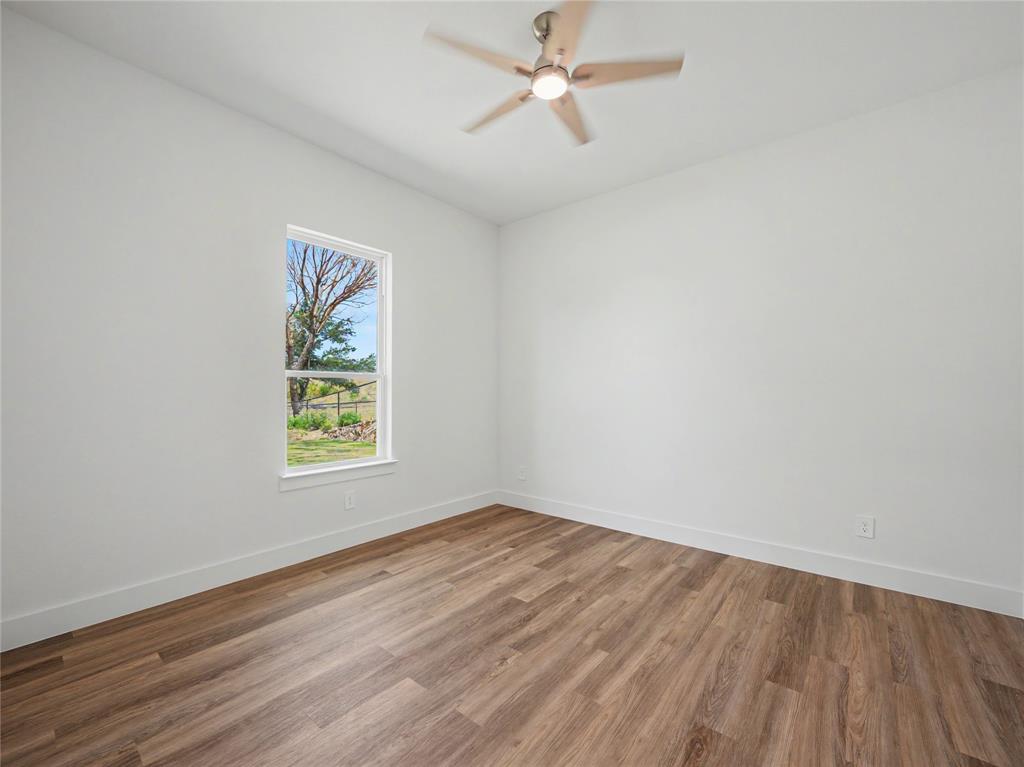 328 Slimp Bluff Azle, TX 76020 - Photo 24 of 30 Room featuring wood-finish flooring, crisp white walls, and a contemporary ceiling fan