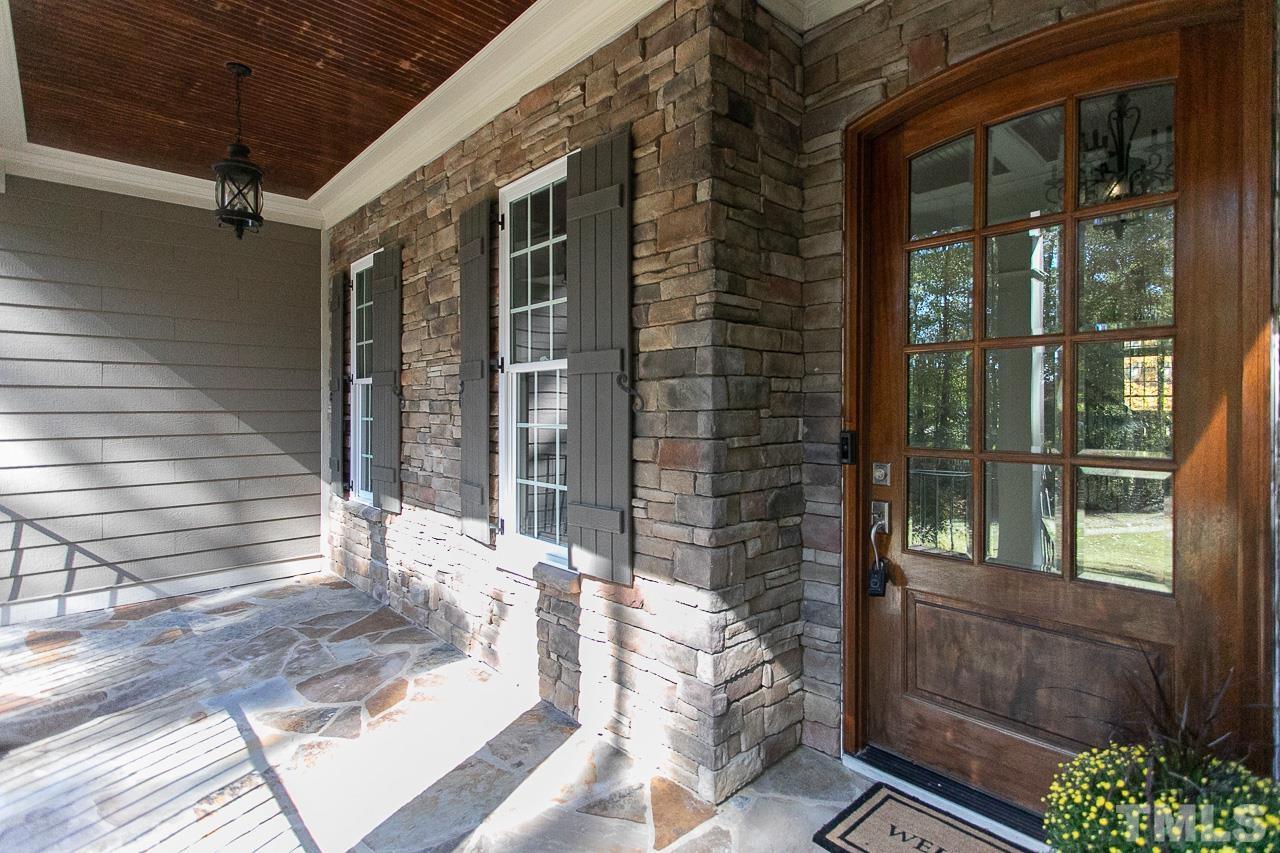 8087 Wake Road Durham, NC 27713 - Photo 3 of 30 a view of a porch with a bench