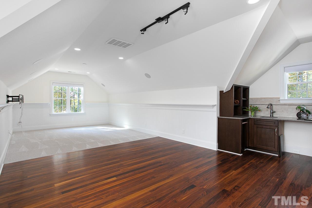 8087 Wake Road Durham, NC 27713 - Photo 24 of 30 a view of kitchen and empty room with wooden floor