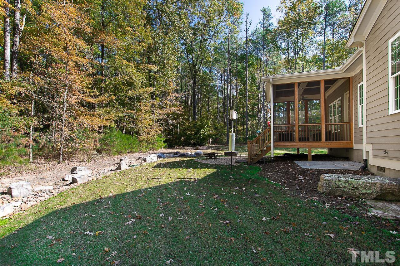 8087 Wake Road Durham, NC 27713 - Photo 26 of 30 a view of a house with backyard and sitting area