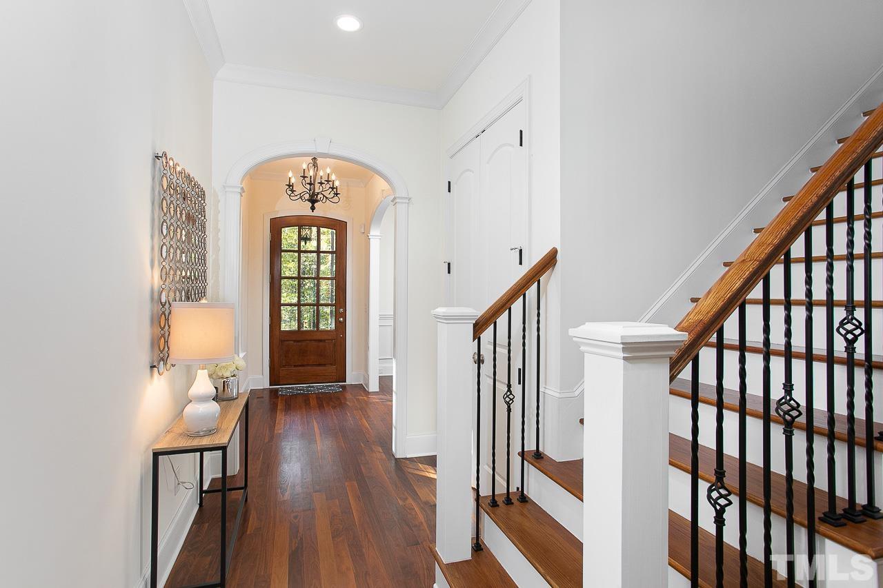 8087 Wake Road Durham, NC 27713 - Photo 4 of 30 a view of a hallway with wooden floor and stairs