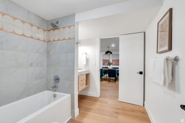 3813 North Foothill Drive Provo, UT 84604 - Photo 43 of 71 Full-sized bathtub with a chrome showerhead and faucet, surrounded by large format wall tiles and a decorative scalloped tile accent band