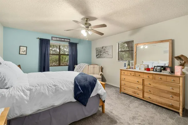 a bedroom with a large bed and a chandelier