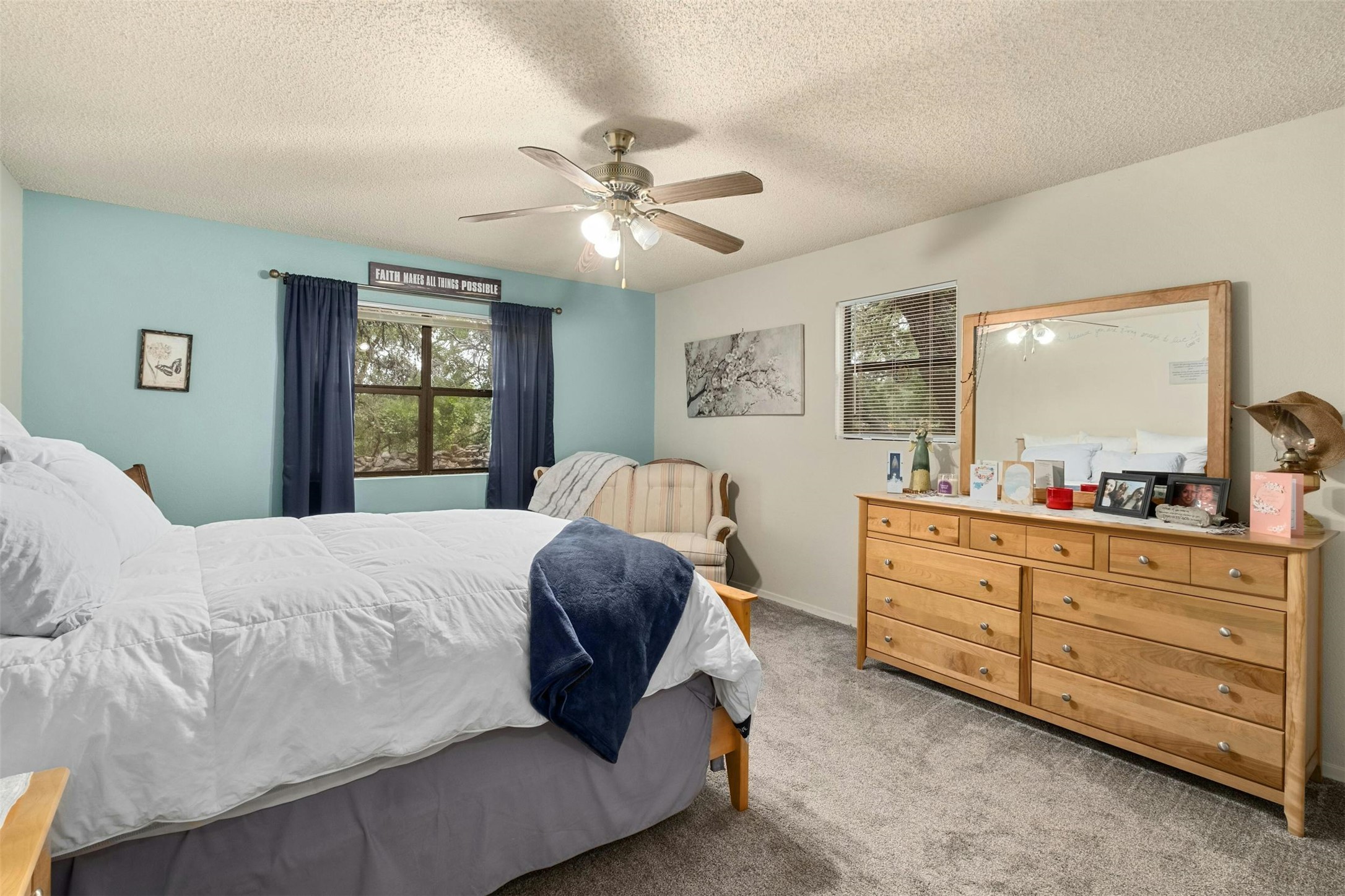 3805 Lone Man Mountain Road Wimberley, TX 78676 - Photo 13 of 19 a bedroom with a large bed and a chandelier