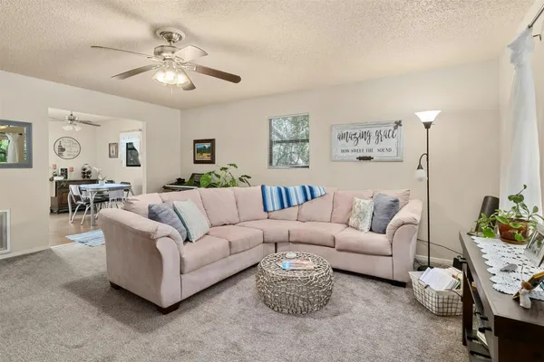 a living room with furniture and a chandelier