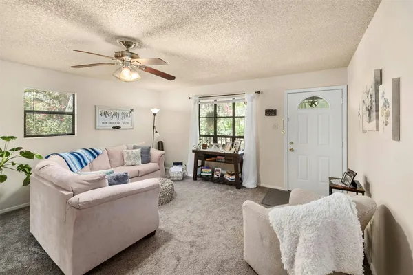 a living room with furniture and a large window