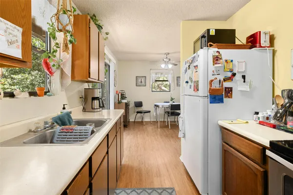 a kitchen with refrigerator and stove