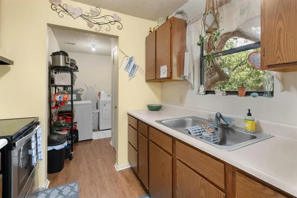 a kitchen with a sink appliances and cabinets