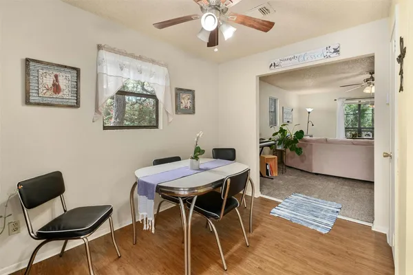 a view of a dining room with furniture and wooden floor