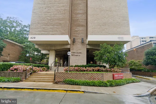 a front view of a house with a garden and plants