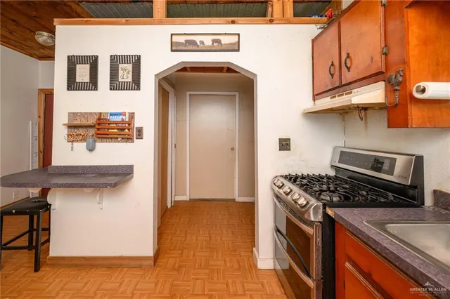 a kitchen with stainless steel appliances granite countertop a stove and a sink