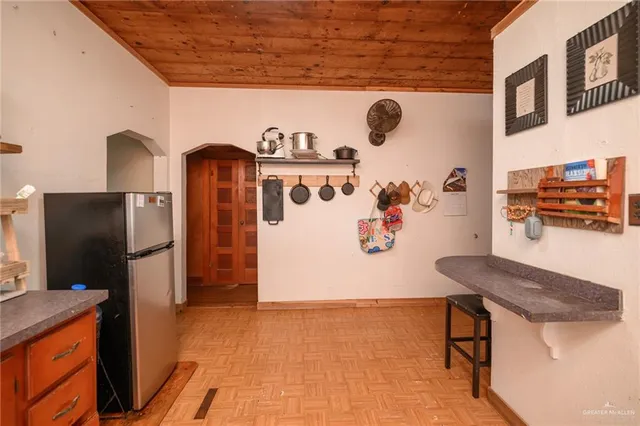 a view of kitchen with stainless steel appliances granite countertop cabinets and a refrigerator