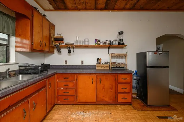 a kitchen with stainless steel appliances granite countertop a refrigerator and a sink