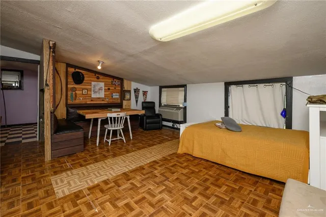 a bedroom with furniture and a rug