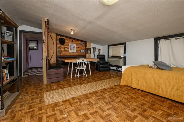 a spacious bedroom with a bed and a table in it