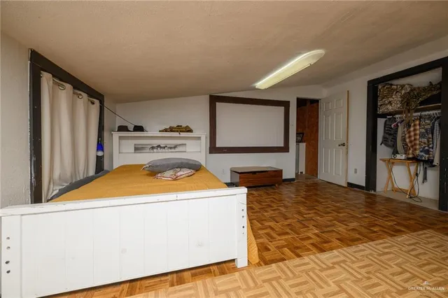 a bedroom with a bed and a dresser