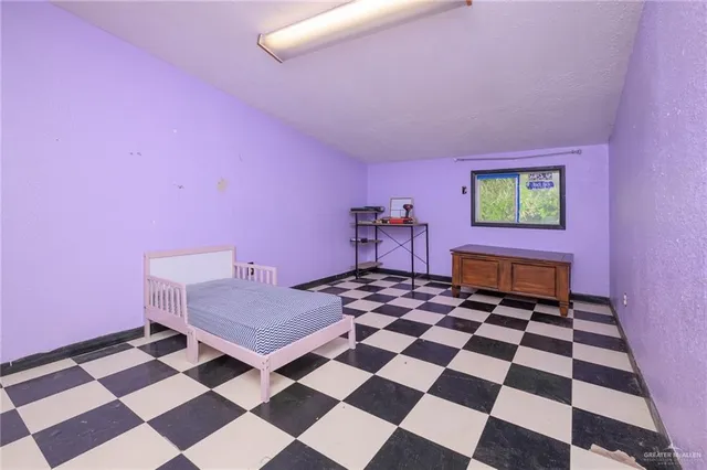 a bedroom with a black and white checkered floor