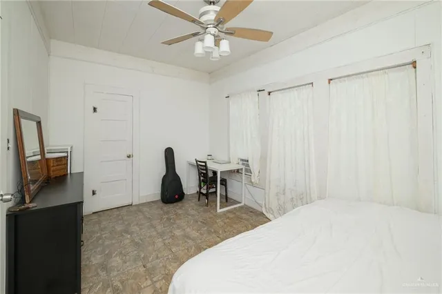 a bedroom with a bed and a television