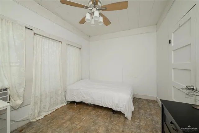 a bedroom with a bed and a ceiling fan