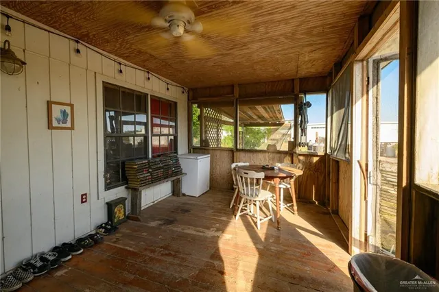 a dining room with wooden floor and furniture