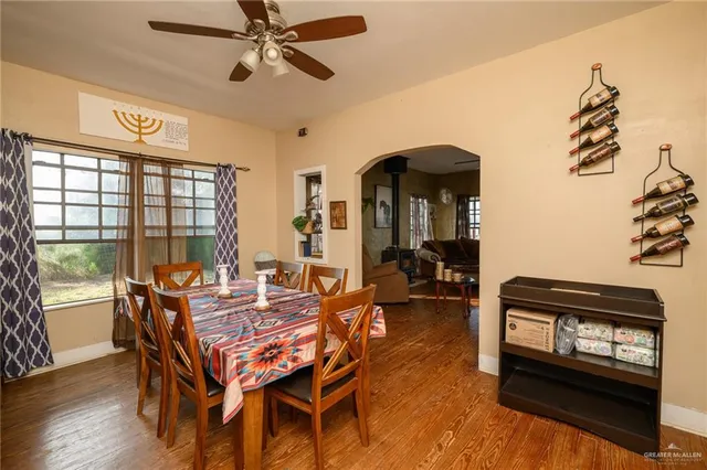 a dining room with furniture a chandelier and wooden floor