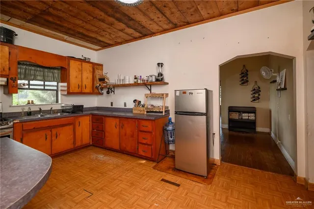 a kitchen with refrigerator and window
