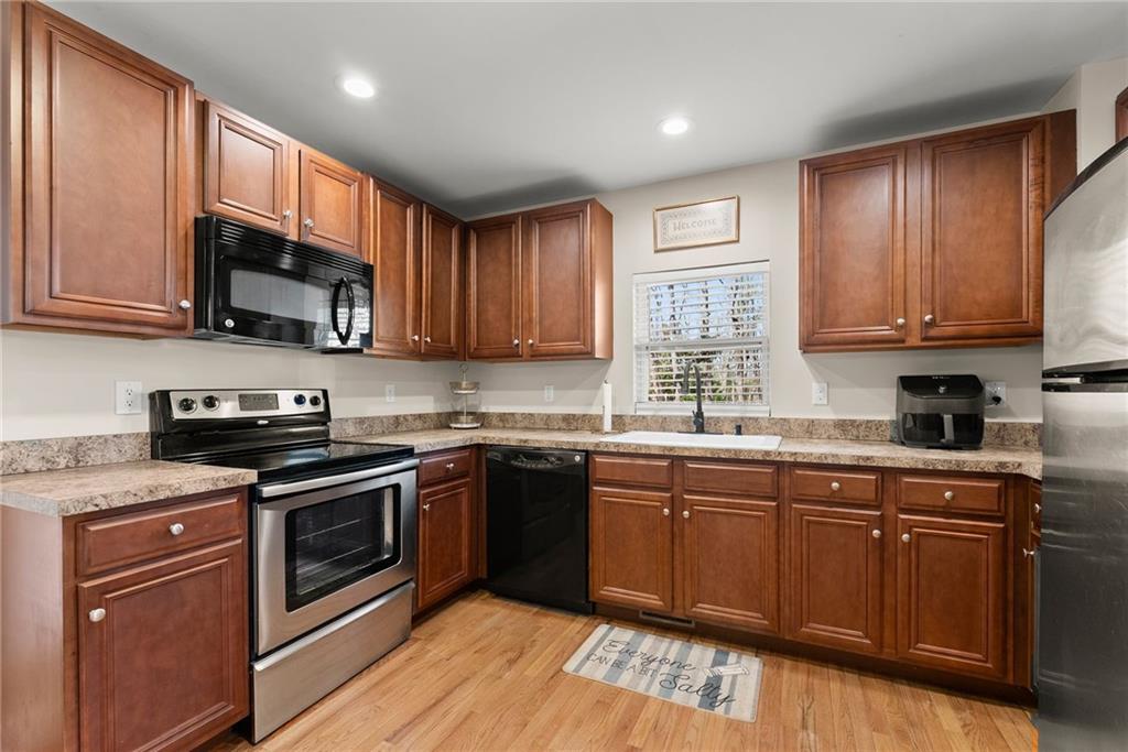 3211 The Trail Road Gainesville, GA 30501 - Photo 11 of 35 a kitchen with stainless steel appliances granite countertop wooden cabinets granite counter tops and a window