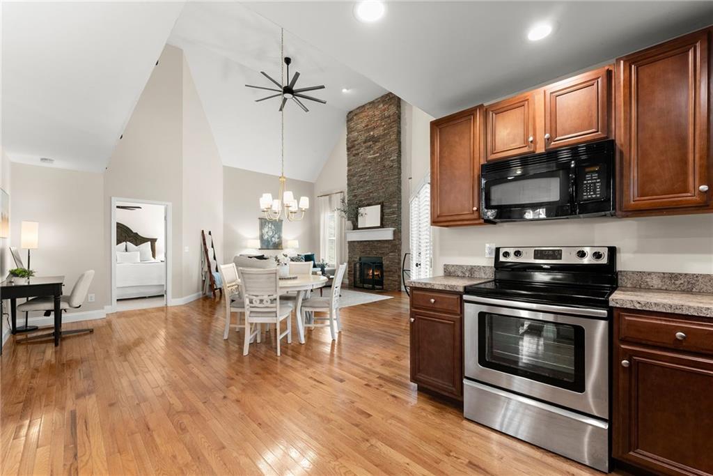 3211 The Trail Road Gainesville, GA 30501 - Photo 12 of 35 a kitchen with microwave a stove and cabinets