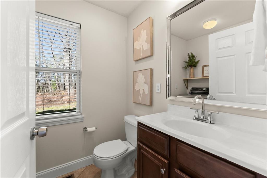3211 The Trail Road Gainesville, GA 30501 - Photo 17 of 35 a bathroom with a sink a toilet and mirror