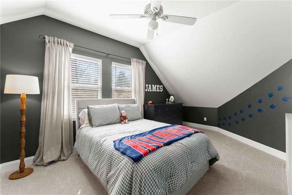 3211 The Trail Road Gainesville, GA 30501 - Photo 20 of 35 a bedroom with a large bed and a chandelier