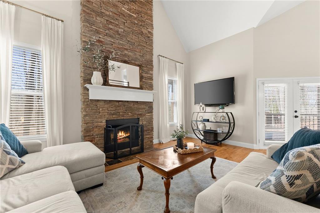 3211 The Trail Road Gainesville, GA 30501 - Photo 4 of 35 a living room with furniture a flat screen tv and a fireplace