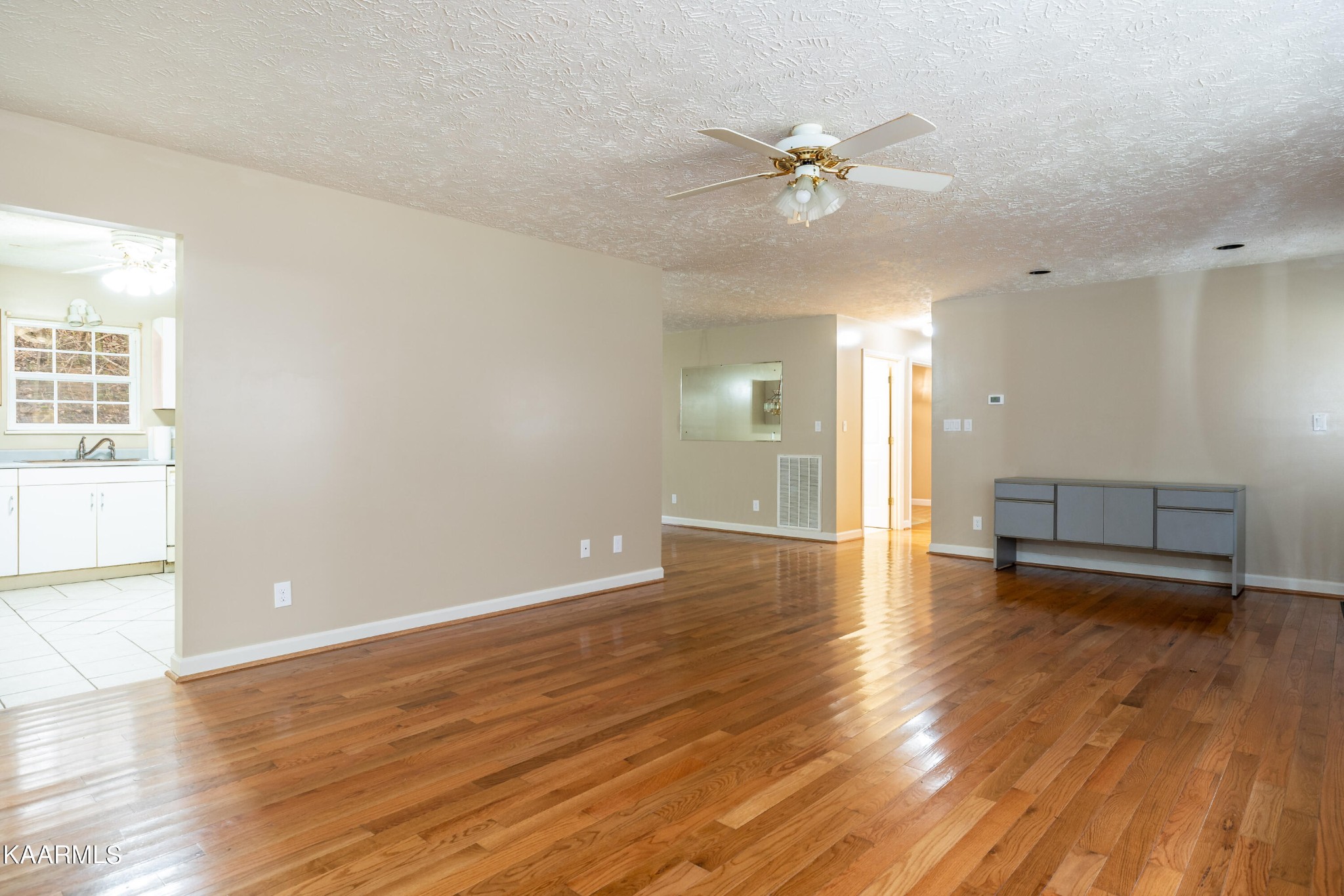 914 Wears Valley Road Townsend, TN 37882 - Photo 12 of 48 an empty room with wooden floor fan and windows
