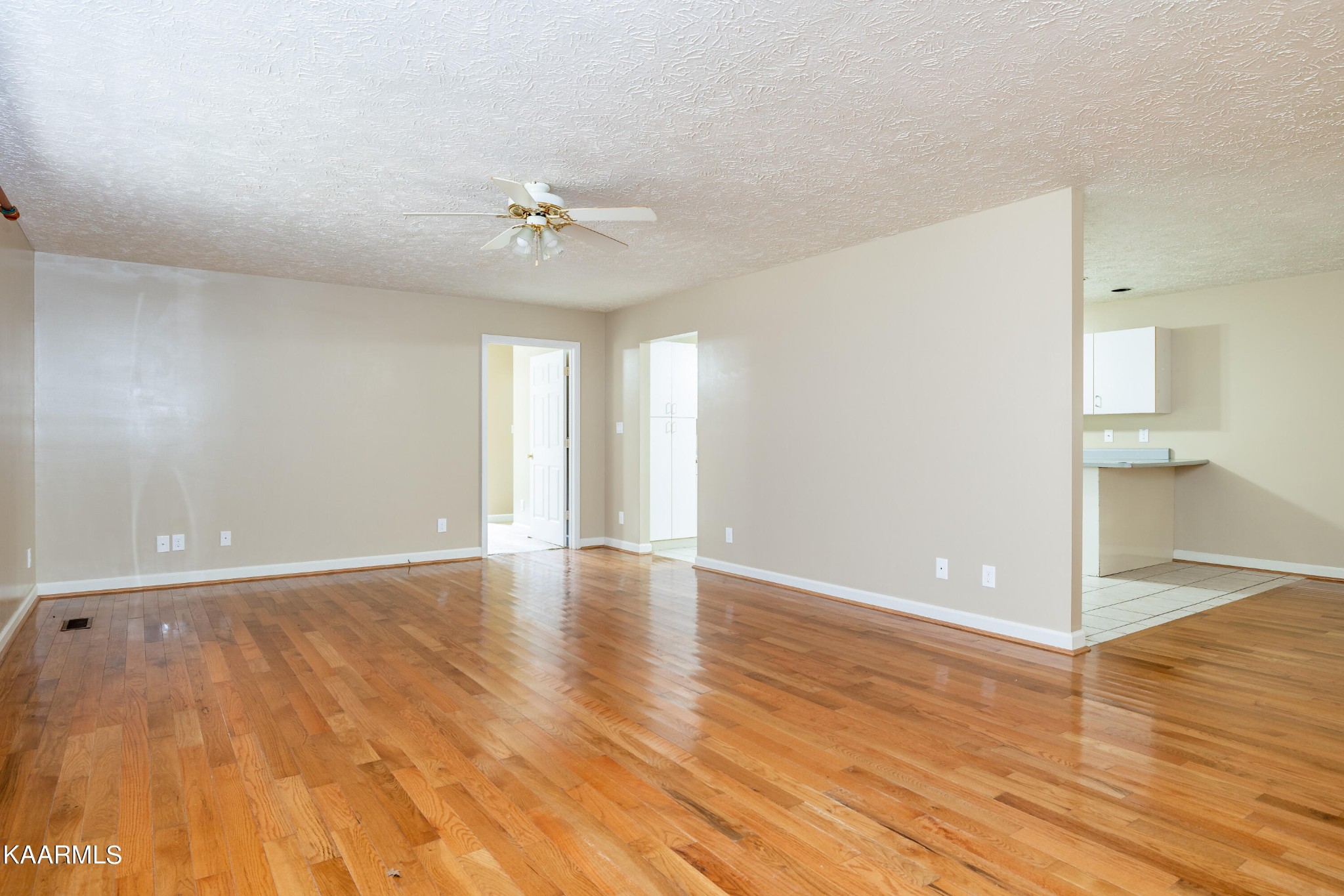 914 Wears Valley Road Townsend, TN 37882 - Photo 9 of 48 an empty room with wooden floor and ceiling fan