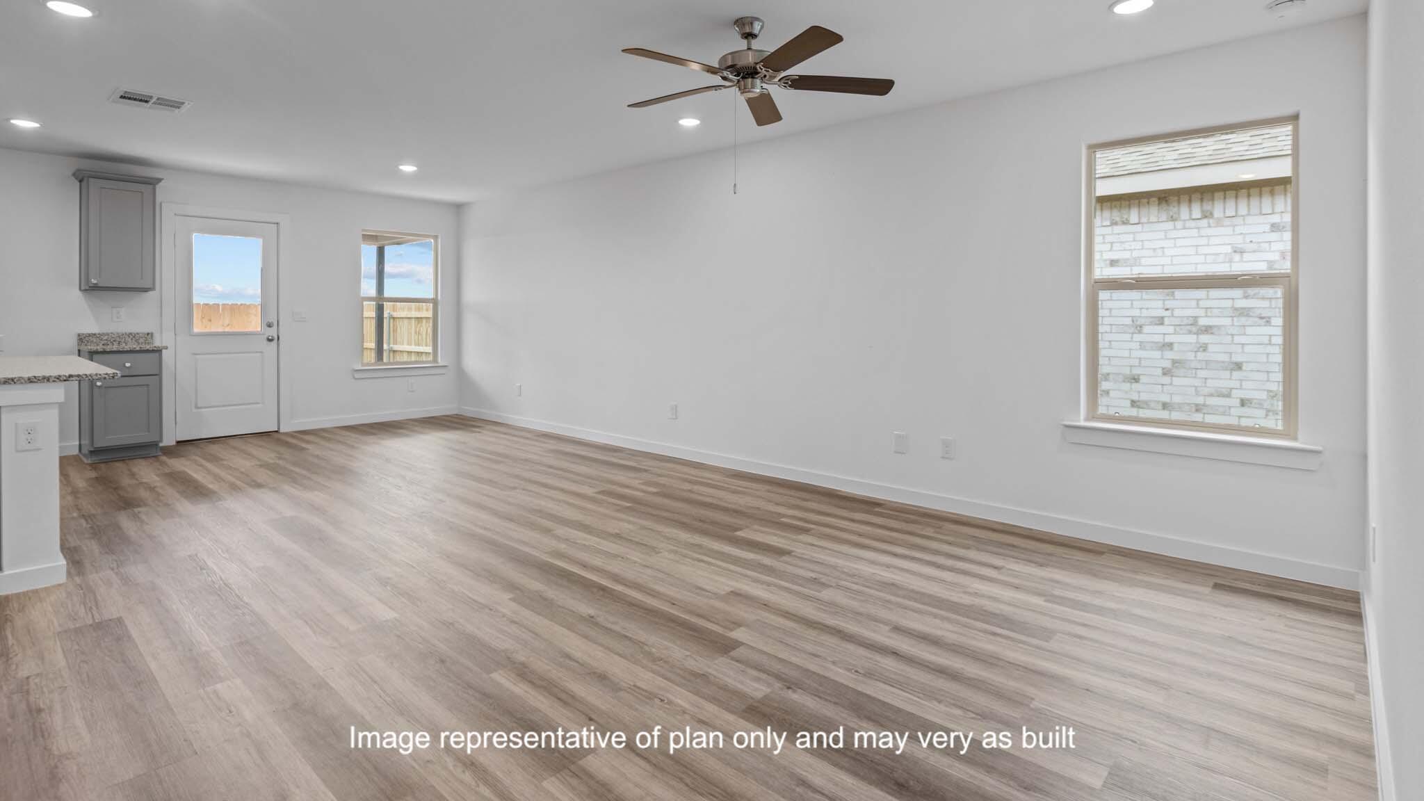 7444 9th Street Lubbock, TX 79416 - Photo 6 of 24 wooden floor in an empty room with a window