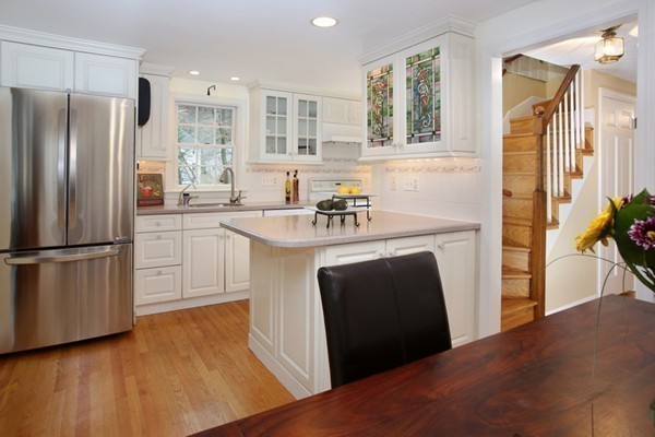 4 Milk Street Lexington, MA 02421 - Photo 5 of 11 a kitchen with stainless steel appliances a refrigerator a sink a stove a chimney a counter space and wooden floor
