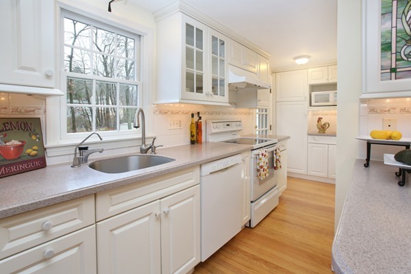 4 Milk Street Lexington, MA 02421 - Photo 6 of 11 a open white kitchen with a sink and dishwasher next to a window