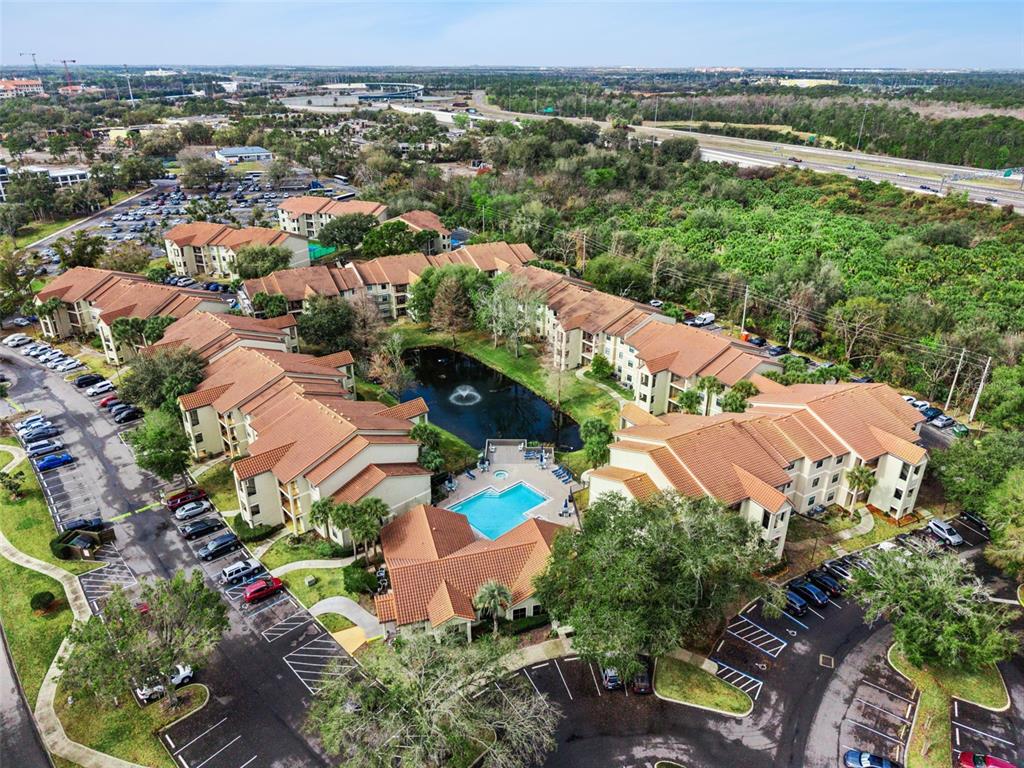 3032 Parkway Boulevard, Unit 305 Kissimmee, FL 34747 - Photo 39 of 40 an aerial view of residential houses with outdoor space and trees