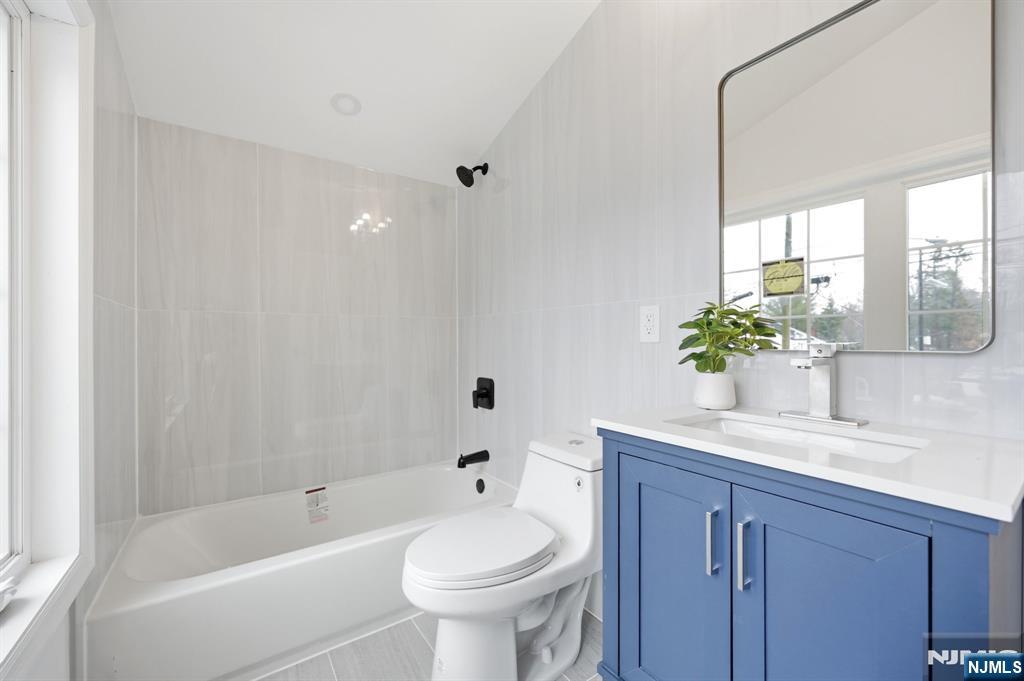 30 West Lawn Road Livingston, NJ 07039 - Photo 14 of 33 a bathroom with a granite countertop sink a toilet and bathtub