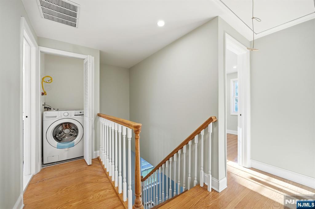 30 West Lawn Road Livingston, NJ 07039 - Photo 15 of 33 a view of a hallway to a livingroom with washer and dryer