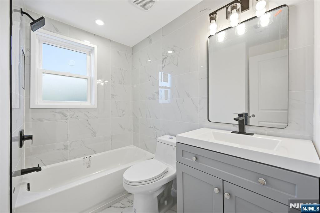 30 West Lawn Road Livingston, NJ 07039 - Photo 21 of 33 a bathroom with a sink a toilet and shower