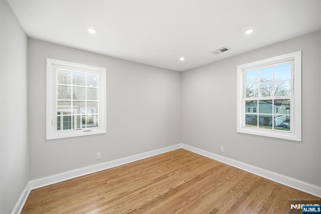 30 West Lawn Road Livingston, NJ 07039 - Photo 22 of 33 an empty room with wooden floor and windows