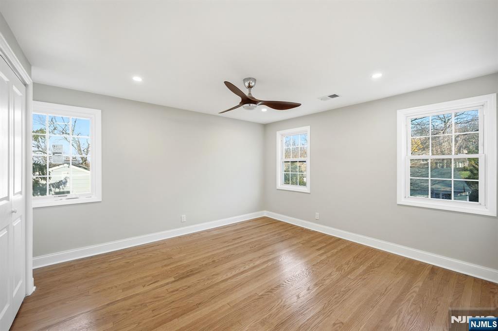 30 West Lawn Road Livingston, NJ 07039 - Photo 23 of 33 a view of an empty room with wooden floor and a window