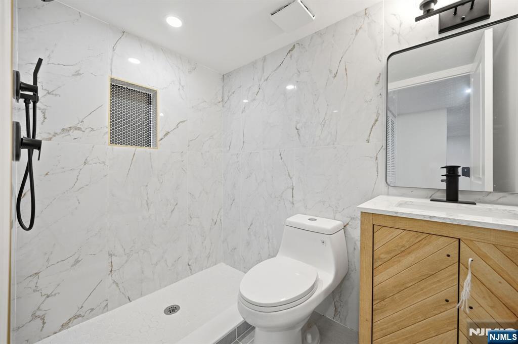 30 West Lawn Road Livingston, NJ 07039 - Photo 27 of 33 a bathroom with a sink a toilet and shower