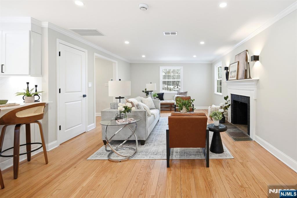 30 West Lawn Road Livingston, NJ 07039 - Photo 6 of 33 a living room with furniture a wooden floor and a fireplace