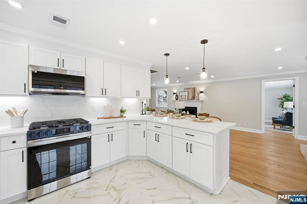 30 West Lawn Road Livingston, NJ 07039 - Photo 8 of 33 a kitchen with a sink stove and cabinets
