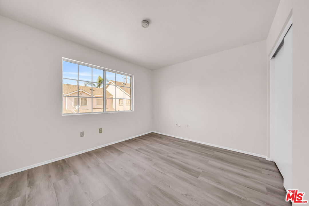 820 West Compton Boulevard, Unit 17 Compton, CA 90220 - Photo 26 of 50 an empty room with wooden floor and windows