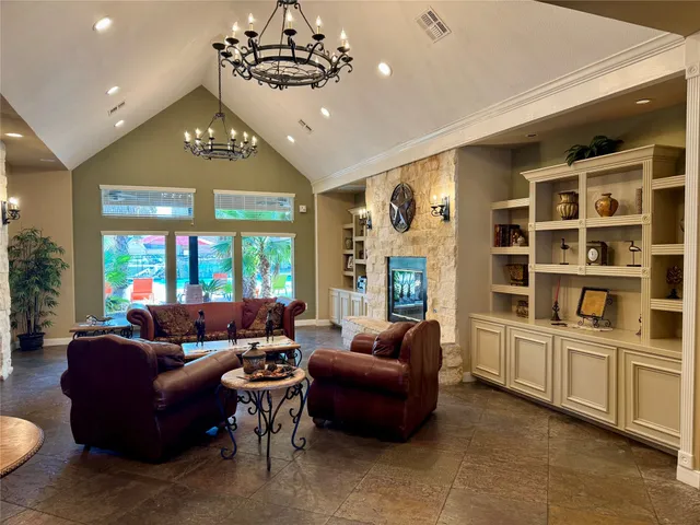 a living room with furniture and a chandelier