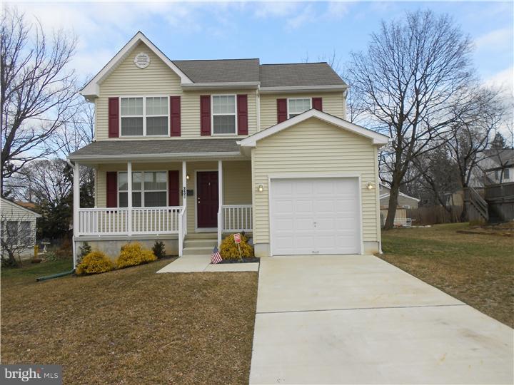 301 East Mill Road Maple Shade, NJ 08052 - Photo 1 of 10 a front view of a house with a yard and garage