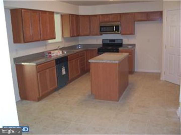 301 East Mill Road Maple Shade, NJ 08052 - Photo 5 of 10 a kitchen with stainless steel appliances granite countertop a stove sink and cabinets