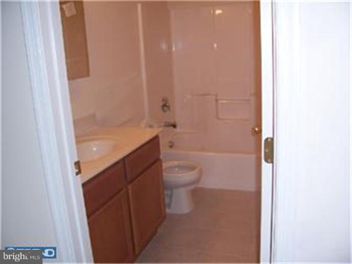 301 East Mill Road Maple Shade, NJ 08052 - Photo 9 of 10 a bathroom with a granite countertop toilet a sink and a bathtub